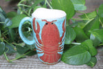 Load image into Gallery viewer, Lobster Lovers Handled Travel Mug, Red Lobster with Pink, Yellow, Purple and White Buoys - 16 oz
