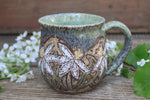 Load image into Gallery viewer, Daffodil Fields and Mountain Lake Carved Mug, 18 oz
