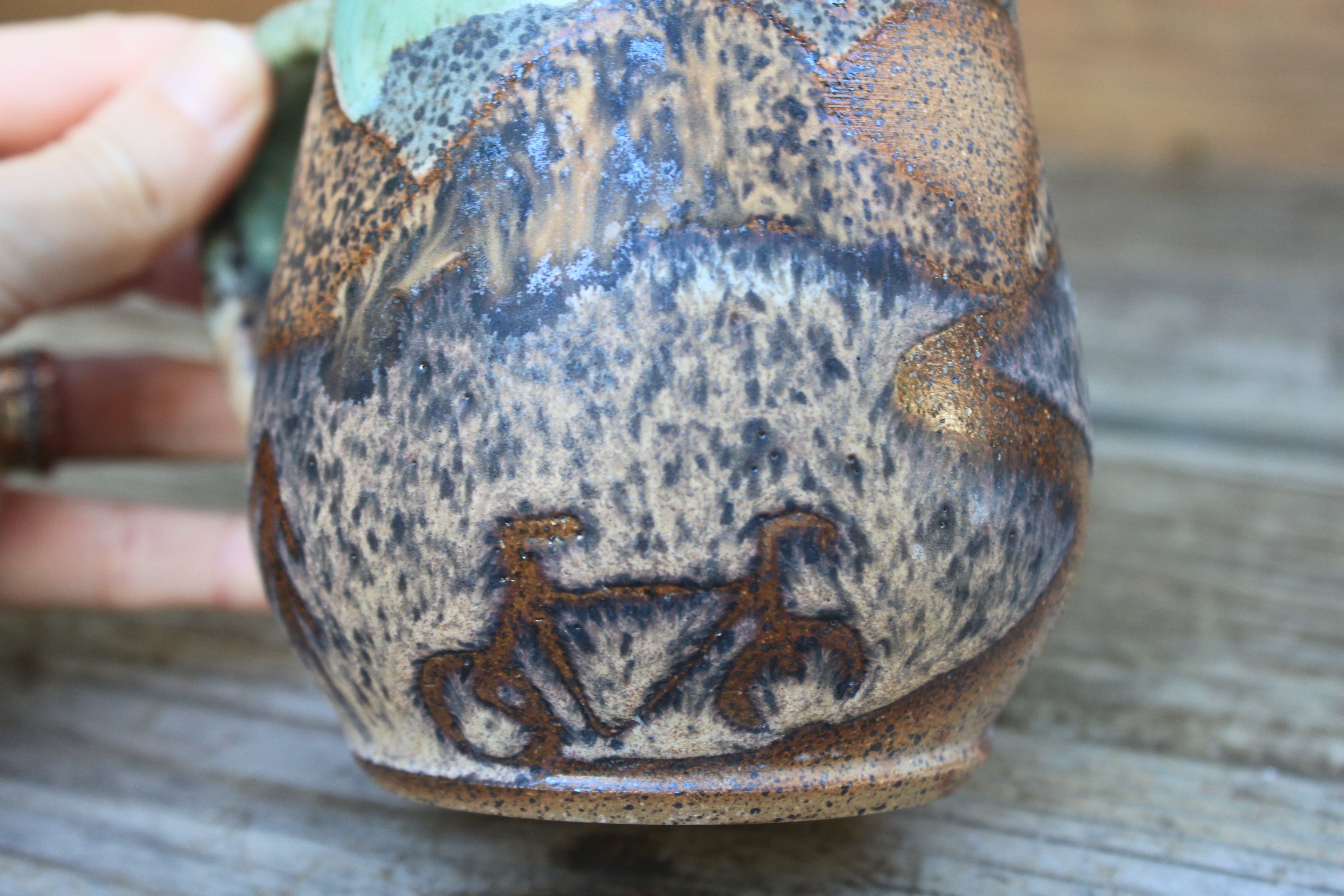 Biking to a Distant Stony Mountain Sunset Mug, 17 oz