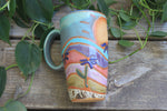 Load image into Gallery viewer, Rainbow Fields and Cone Flower Dreams Handled Travel Mug, 17 oz
